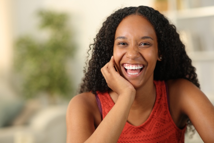 Woman laughing at camera after professional teeth whitening treatment in Portage, MI